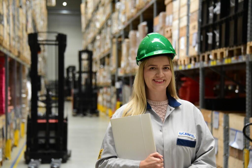 Scanfil employee working at factory with value-added distribution services that Scanfil offers -turnkey manufacturing, assembly, warehousing, cross docking, break bulk, and order consolidation to meet end user needs.