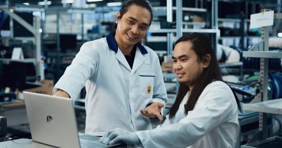 Two Scanfil employees working with product design on computer