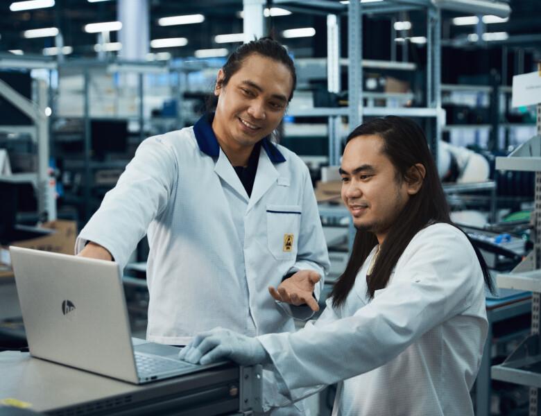 Two Scanfil employees working with product design on computer